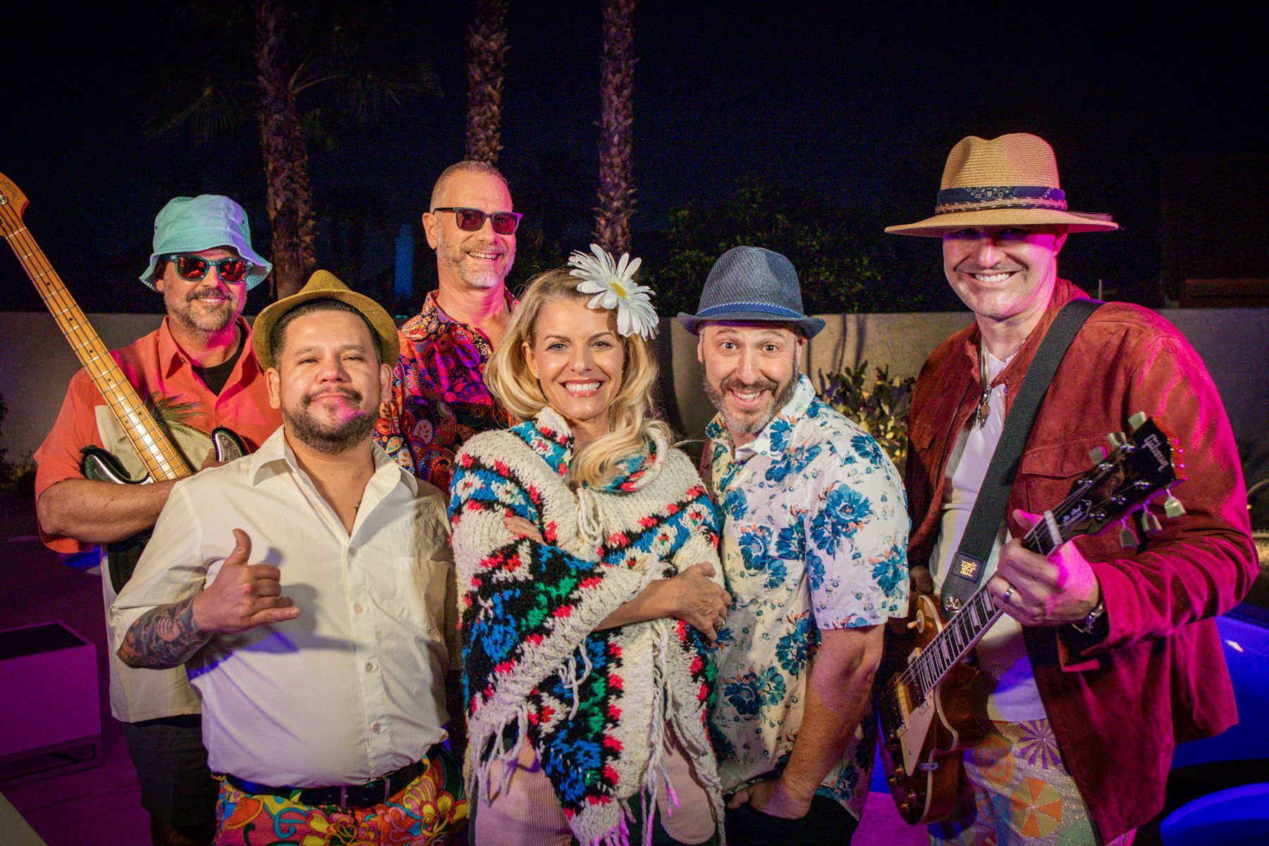 The six members of Desert Hot Things smiling together at night